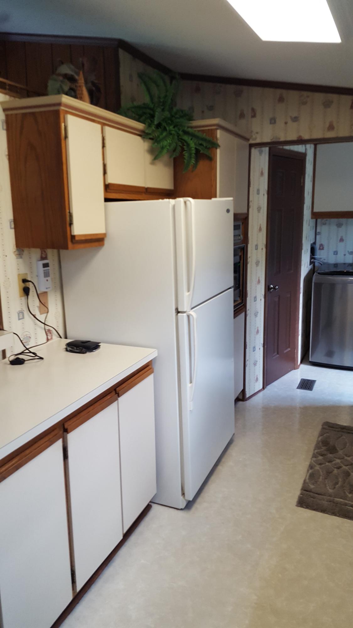 2771 Rutrough Road Southeast Roanoke, VA 24014 - Photo 10 of 31 a kitchen with a refrigerator and a sink