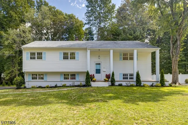 a front view of house with outdoor seating and yard