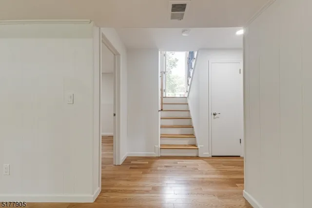 a view of a patio with table and chairs and floor to ceiling window