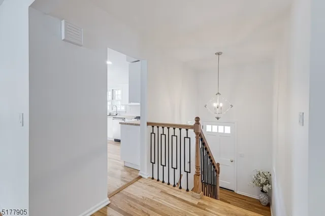 a view of hallway with wooden floor