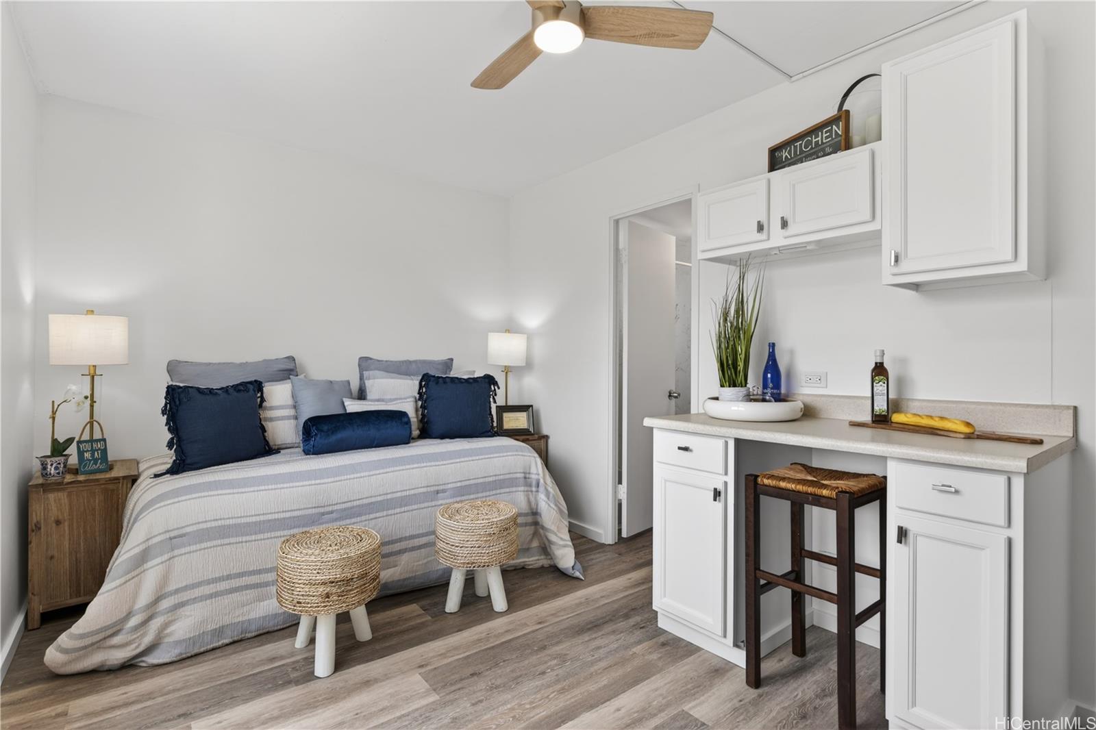 98-1038 Moanalua Road, Unit 7608 Aiea, HI 96701 - Photo 17 of 25 a bedroom with a bed and a table in it