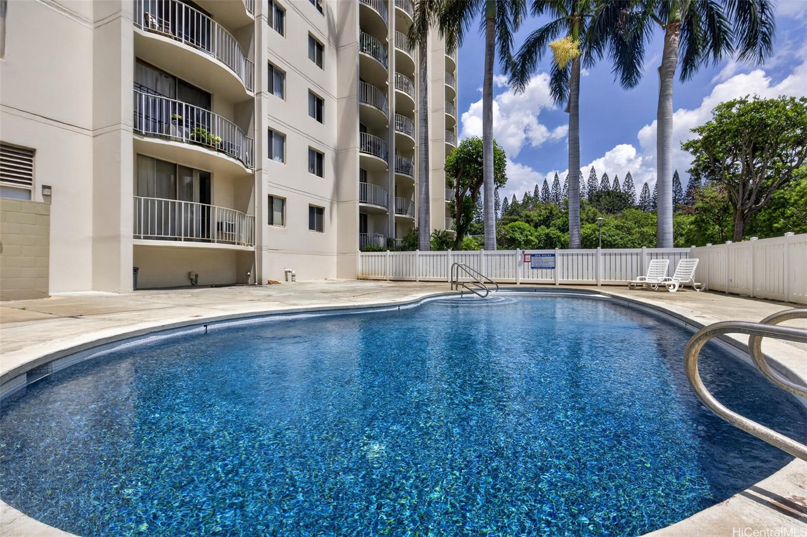 98-1038 Moanalua Road, Unit 7608 Aiea, HI 96701 - Photo 22 of 25 a view of a building with a swimming pool