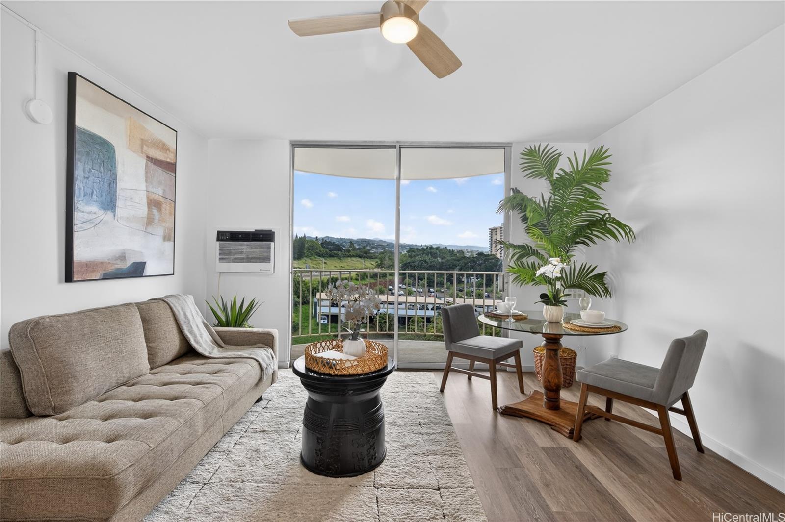 98-1038 Moanalua Road, Unit 7608 Aiea, HI 96701 - Photo 3 of 25 a living room with furniture a lamp and a potted plant