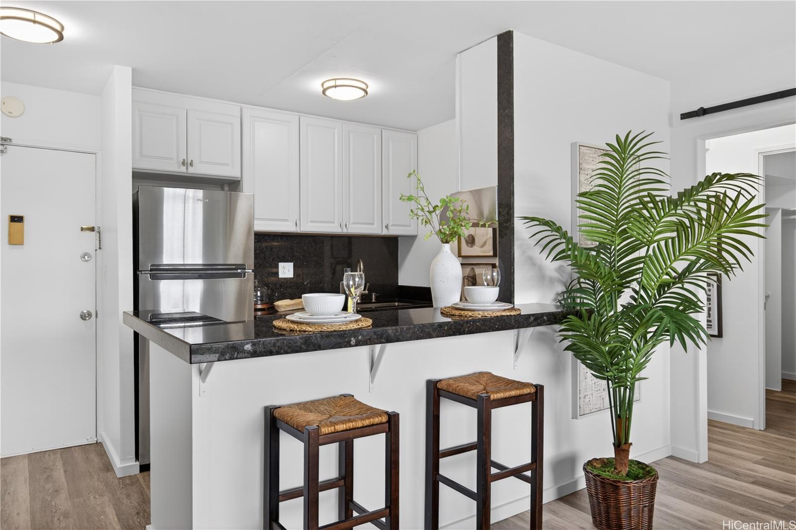 98-1038 Moanalua Road, Unit 7608 Aiea, HI 96701 - Photo 8 of 25 a kitchen with stainless steel appliances a table and chairs in it
