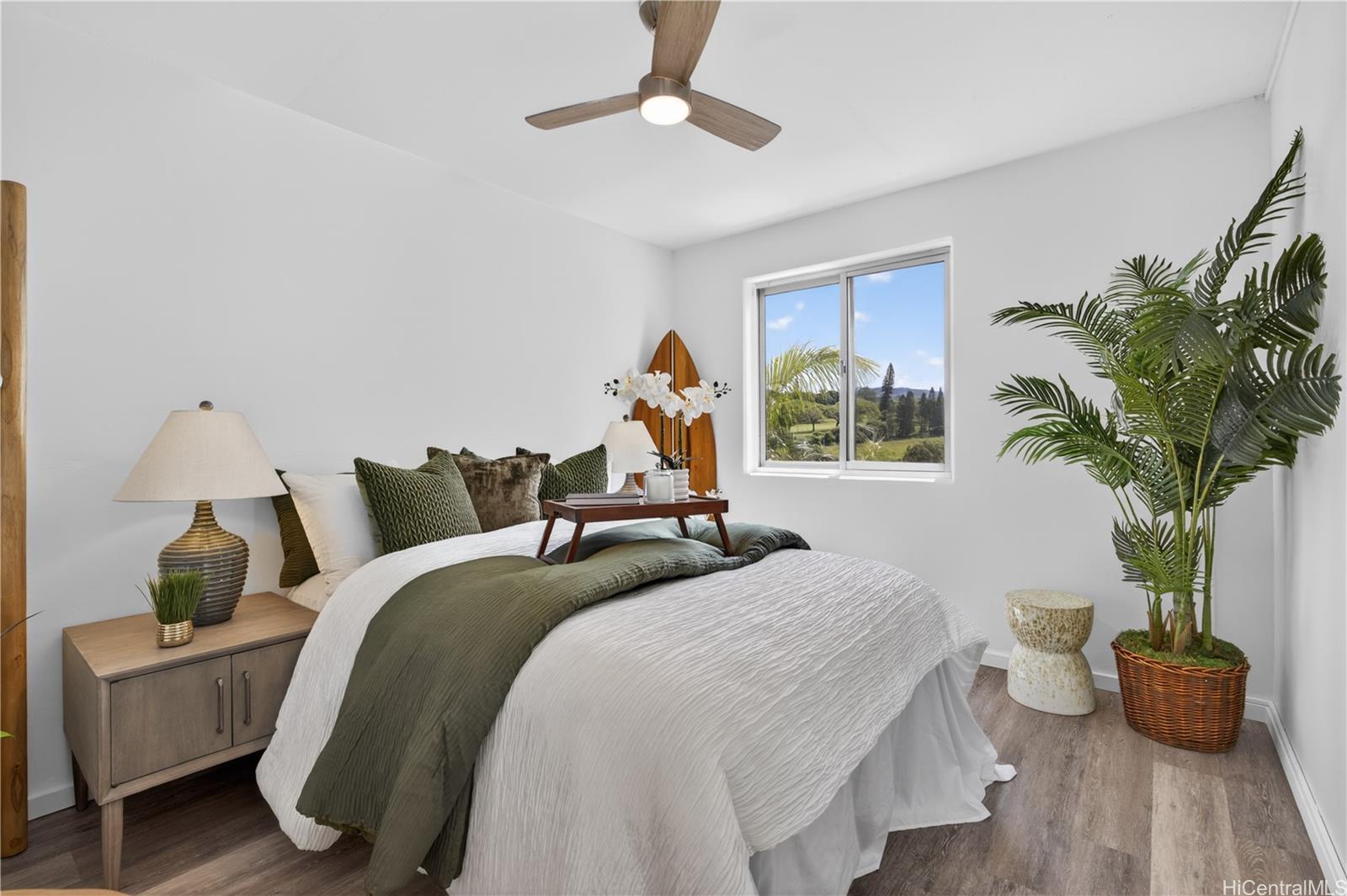 98-1038 Moanalua Road, Unit 7608 Aiea, HI 96701 - Photo 10 of 25 a bedroom with bed and a potted plant