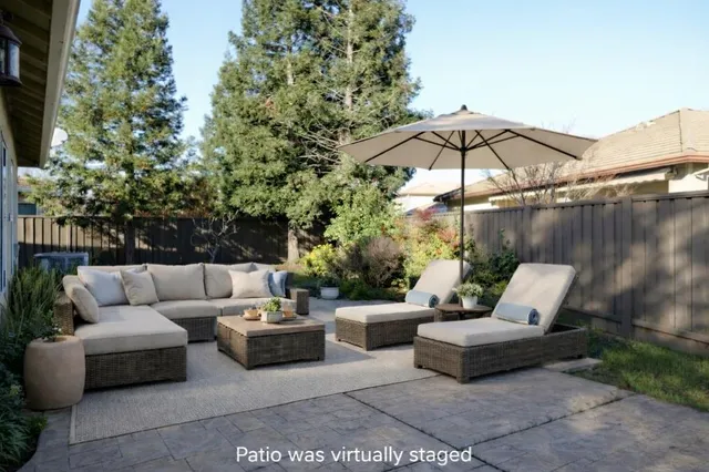 a view of a patio with couches and a fire pit