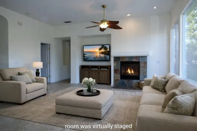 a living room with furniture a fireplace and a flat screen tv