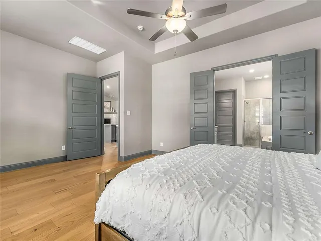 a bedroom with a bed and a chandelier