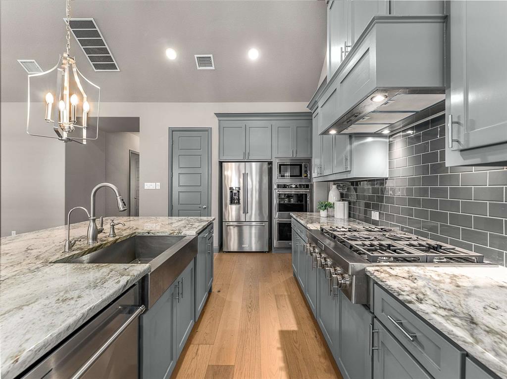 1930 Inwood Lane Prosper, TX 75078 - Photo 3 of 37 a kitchen with stainless steel appliances granite countertop a sink stove and refrigerator