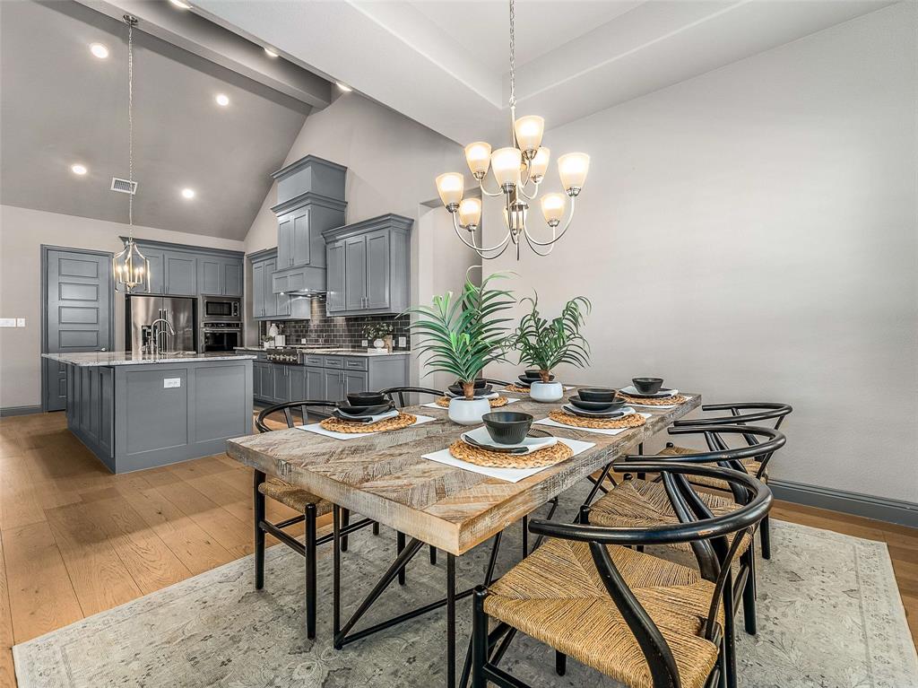 1930 Inwood Lane Prosper, TX 75078 - Photo 9 of 37 a view of a dining room with furniture and a chandelier