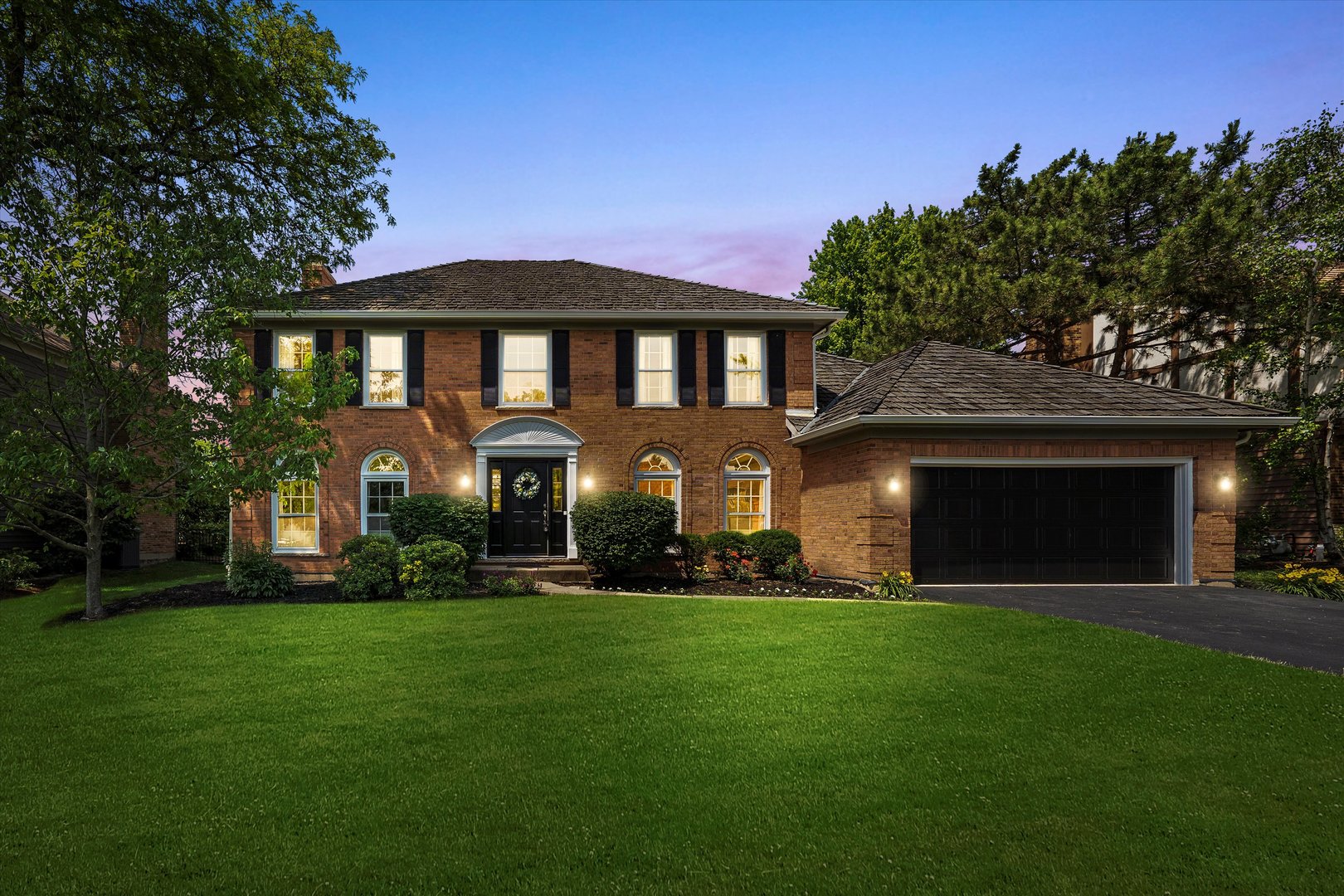 211 Danada Drive Wheaton, IL 60189 - Photo 2 of 51 a front view of a house with a garden
