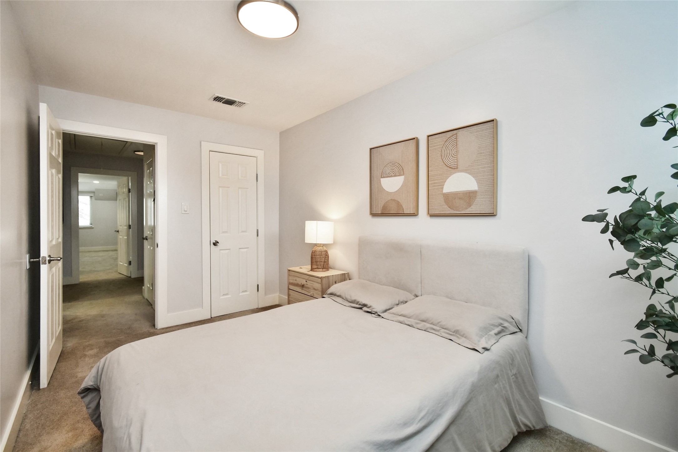 6426 Kentwick Drive, Unit 24/4 Houston, TX 77084 - Photo 30 of 36 a bedroom with a bed and a potted plant