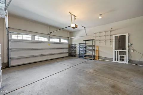 a view of a kitchen with wooden floor and a window