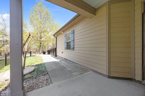 a view of kitchen with stainless steel appliances granite countertop a stove top oven a sink dishwasher a refrigerator and a dining table with wooden floor