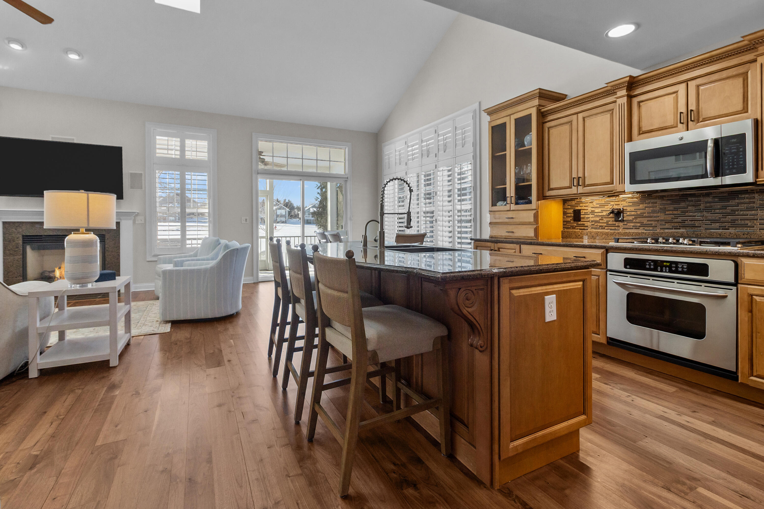 813 Eagleton Drive, Unit 4679 Geneva, WI 53147 - Photo 9 of 53 Kitchen open to family room, vaulted ceilings, access to screened porch and extended patio.