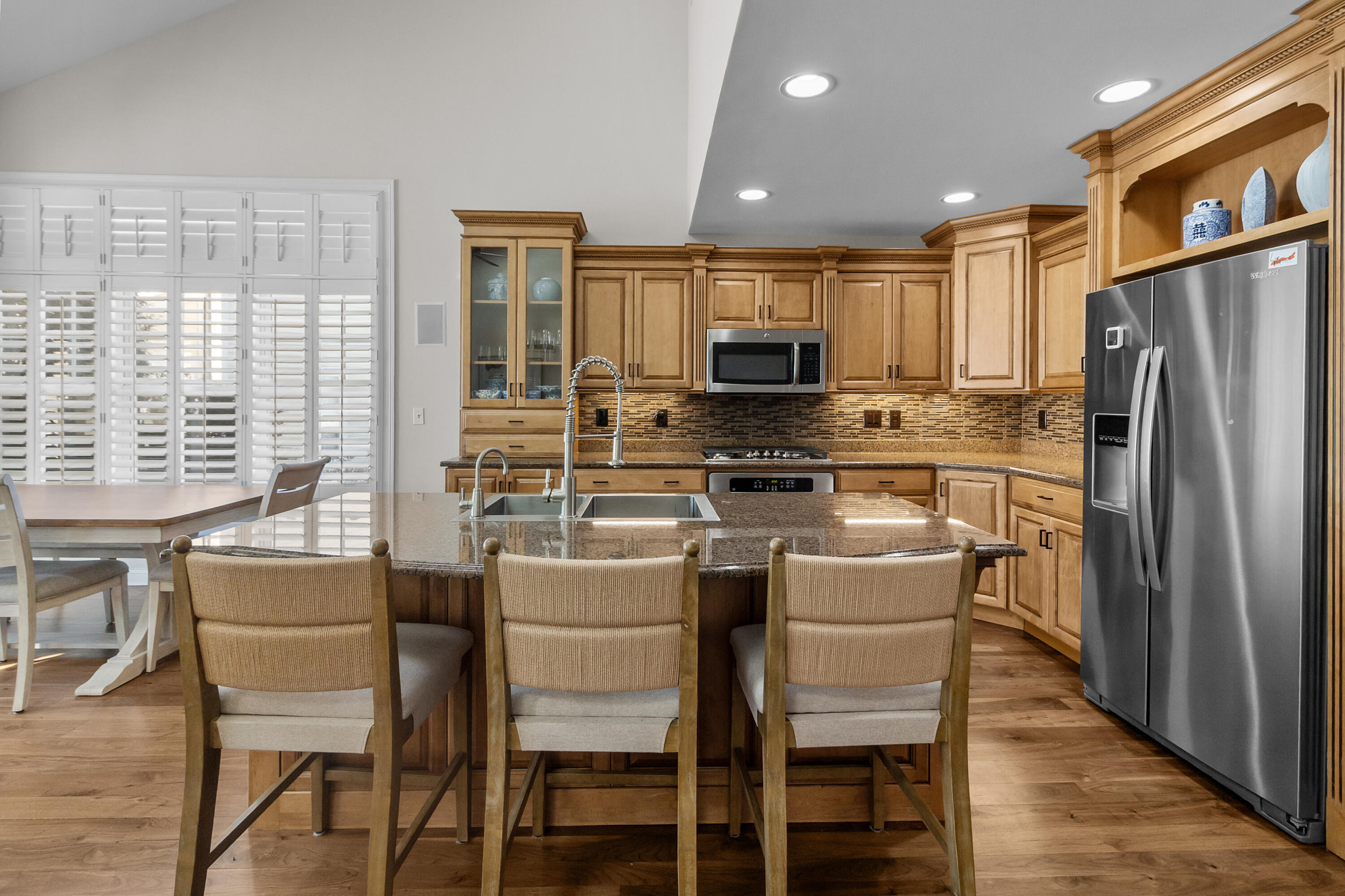 813 Eagleton Drive, Unit 4679 Geneva, WI 53147 - Photo 10 of 53 Kitchen open to family room, vaulted ceilings, access to screened porch and extended patio.