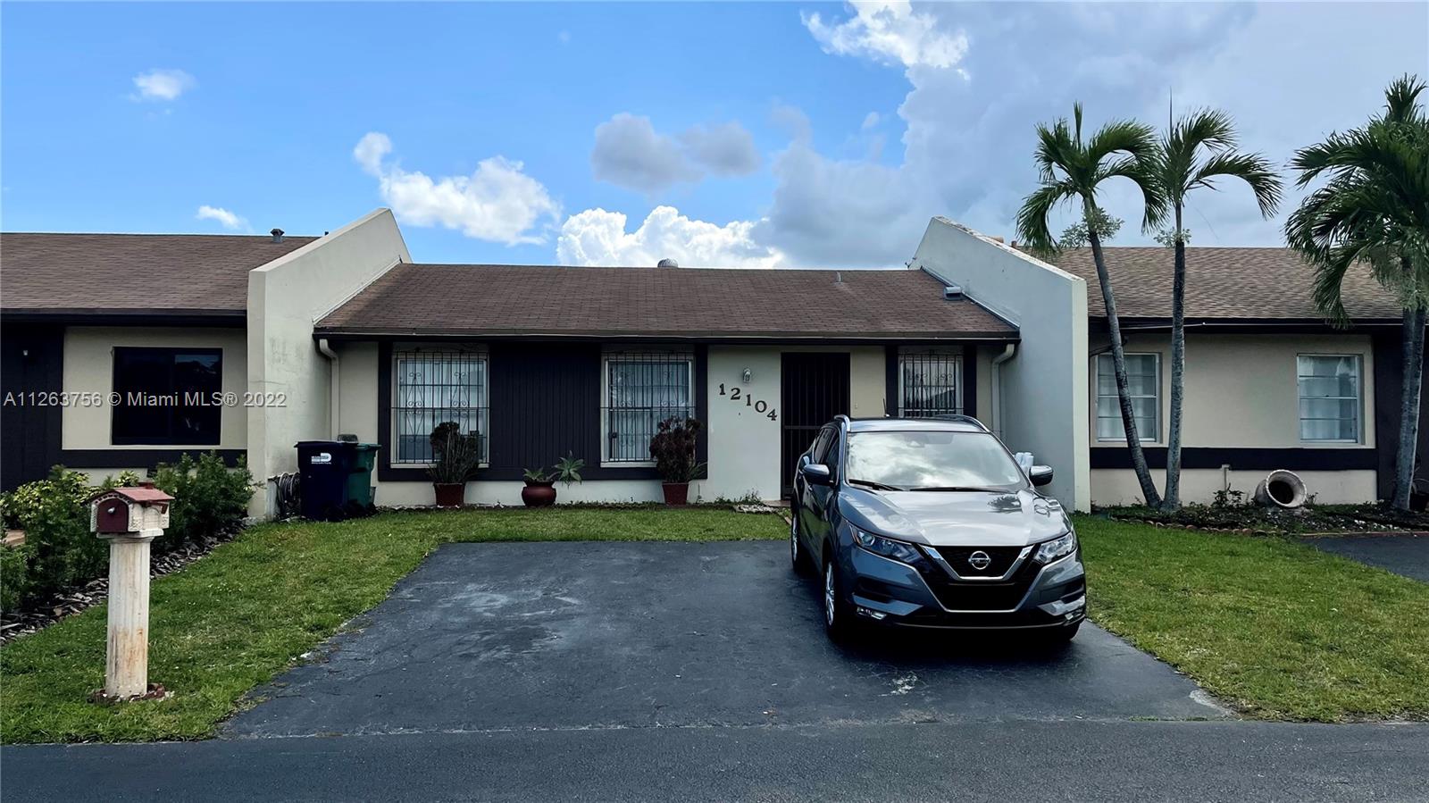 a front view of a house with garden and porch