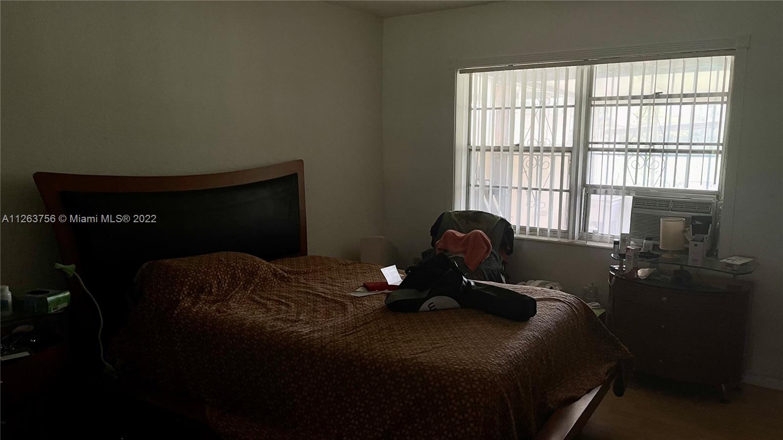 12104 Southwest 110th St Circle South Miami, FL 33186 - Photo 4 of 8 a bed sitting in a bedroom next to a window