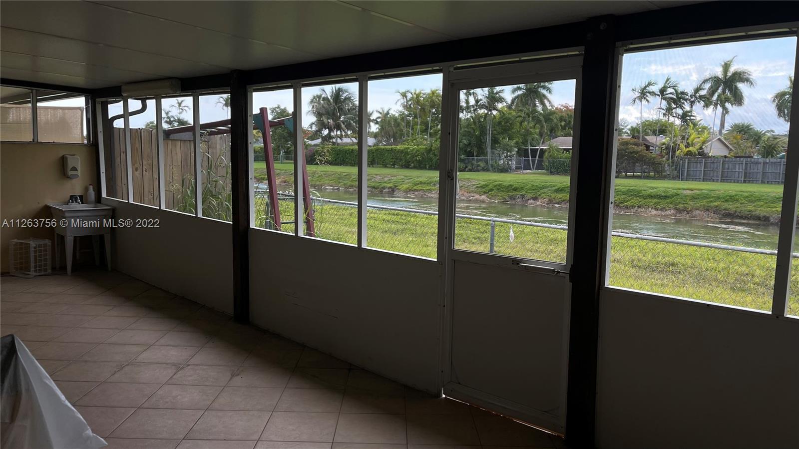 12104 Southwest 110th St Circle South Miami, FL 33186 - Photo 7 of 8 a view of an empty room with a large window
