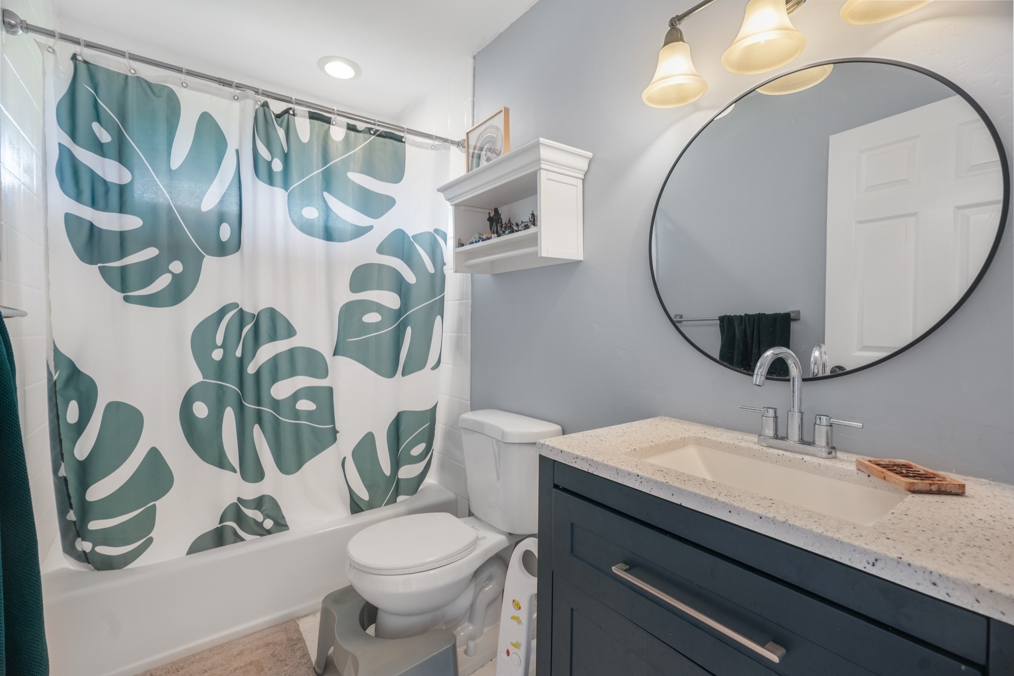 5974 Lokelani Road Kapaa, HI 96746 - Photo 13 of 24 a bathroom with a granite countertop toilet sink and mirror