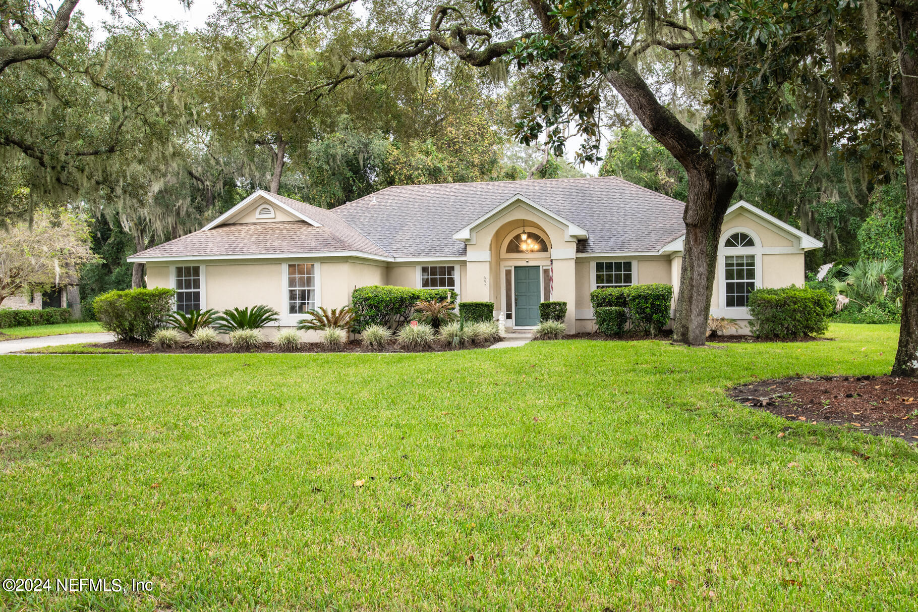 697 Standish Drive St. Augustine, FL 32086 - Photo 1 of 45 a front view of a house with garden