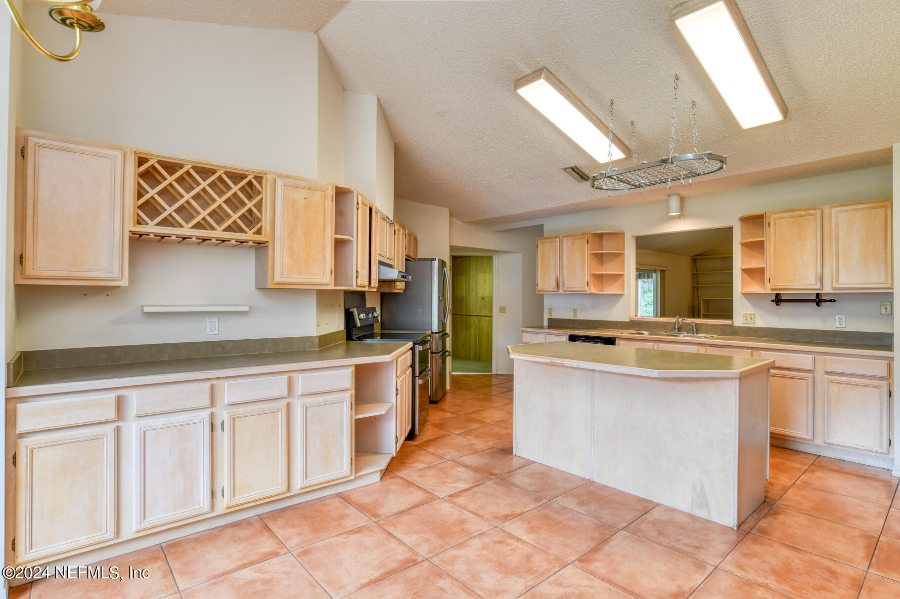 697 Standish Drive St. Augustine, FL 32086 - Photo 18 of 45 a large kitchen with cabinets and wooden floor