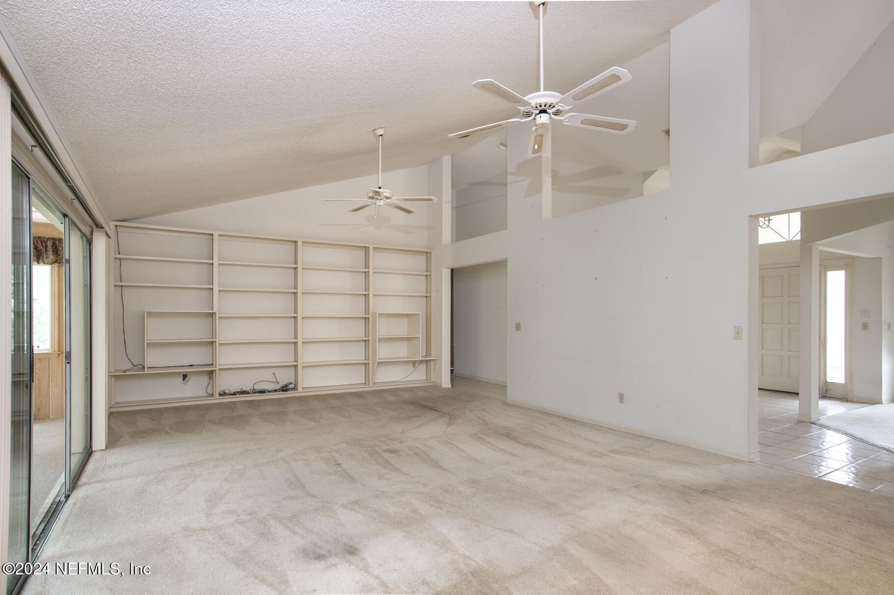 697 Standish Drive St. Augustine, FL 32086 - Photo 22 of 45 an empty room with windows and fan