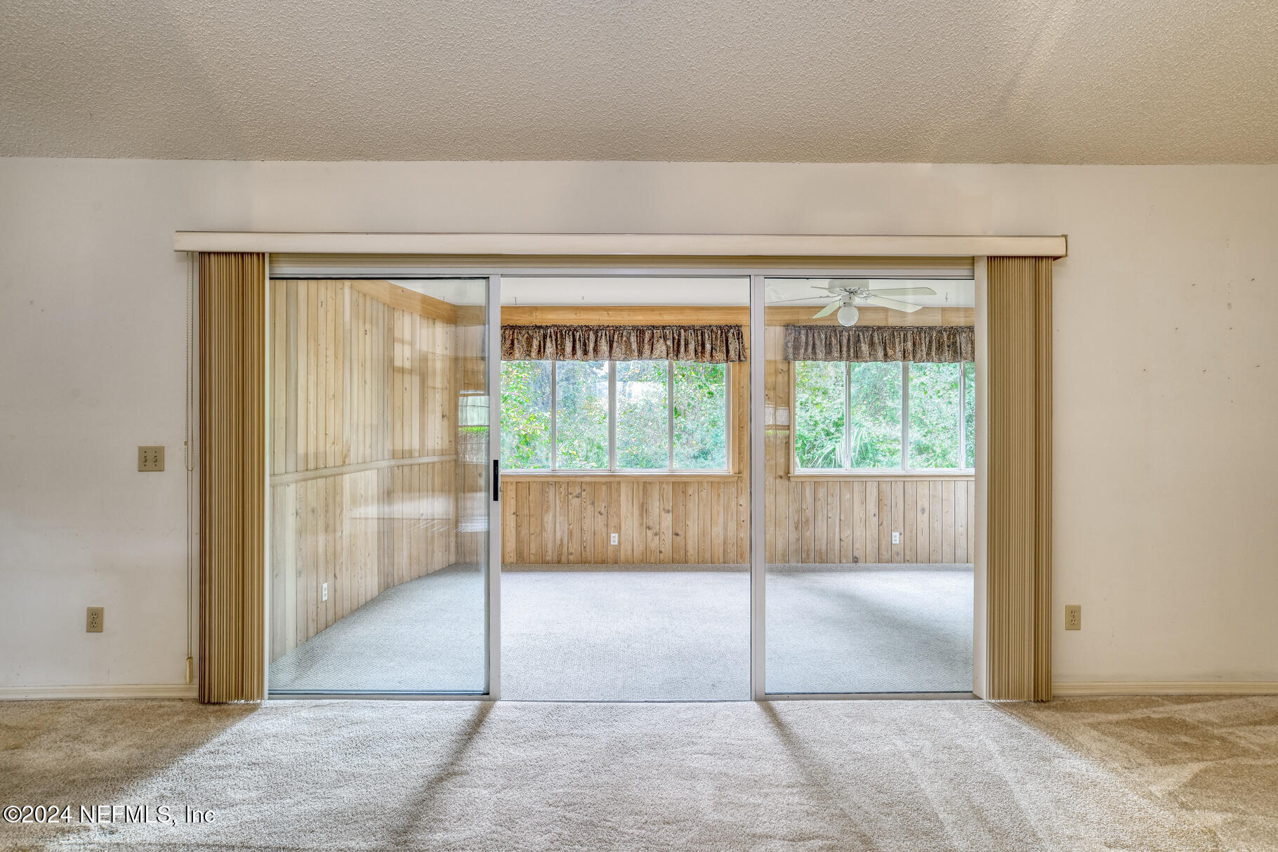 697 Standish Drive St. Augustine, FL 32086 - Photo 23 of 45 a view of an empty room with glass door