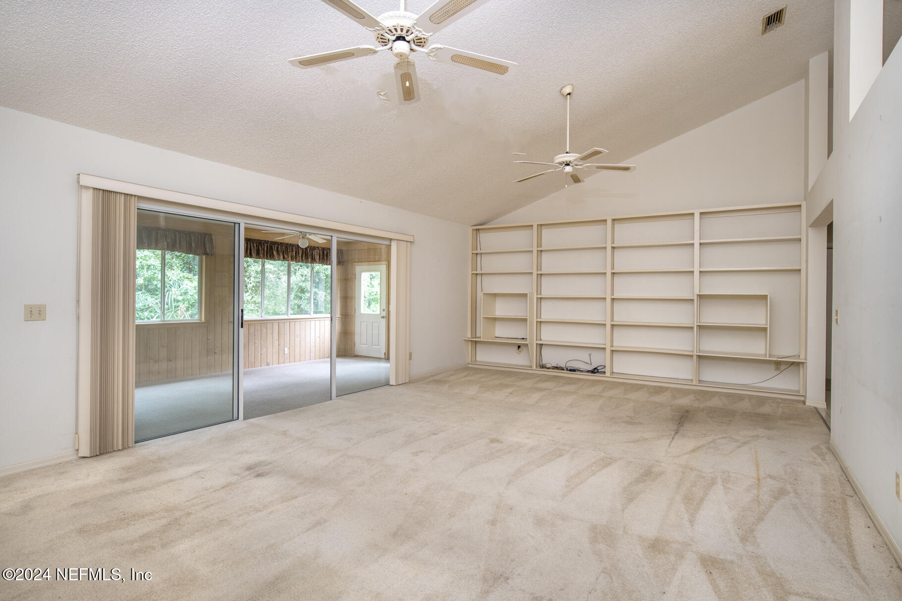 697 Standish Drive St. Augustine, FL 32086 - Photo 3 of 45 an empty room with windows and fan
