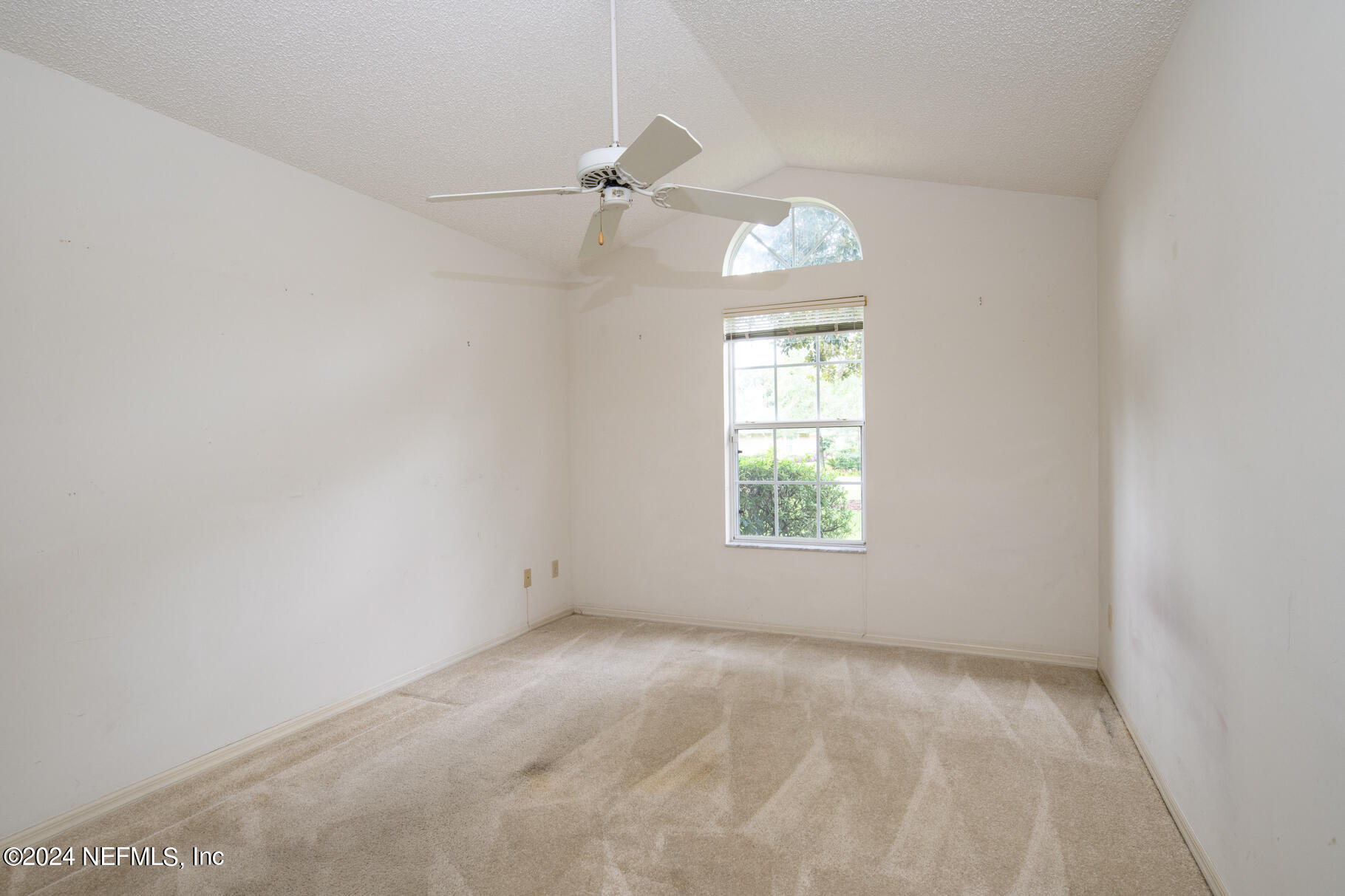 697 Standish Drive St. Augustine, FL 32086 - Photo 31 of 45 an empty room with a window and a fan