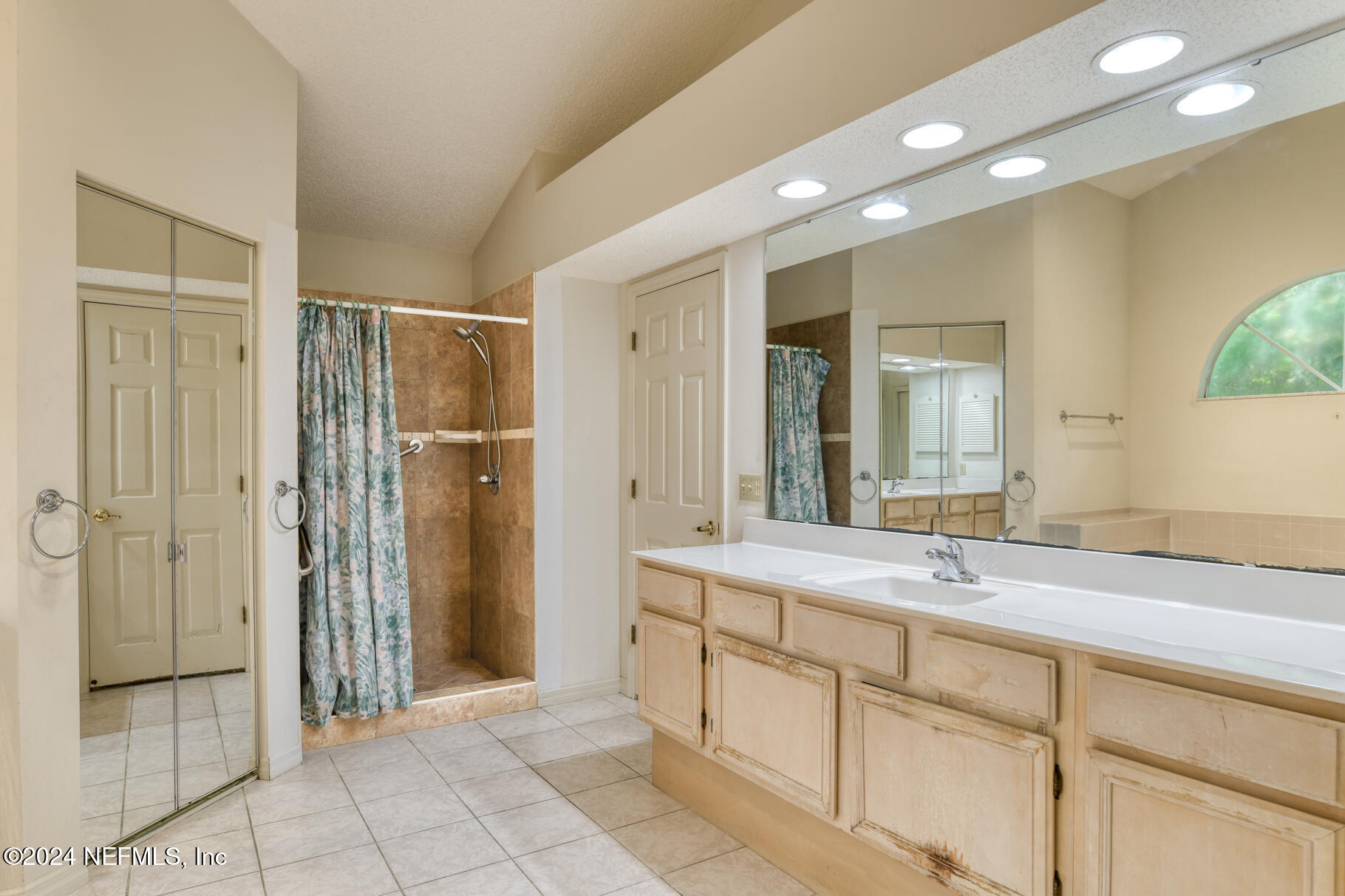 697 Standish Drive St. Augustine, FL 32086 - Photo 4 of 45 a spacious bathroom with a shower sink and mirror