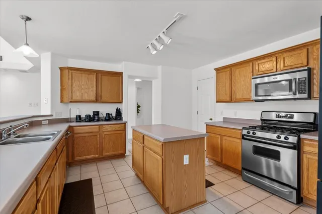 a kitchen with stainless steel appliances granite countertop a stove and a sink