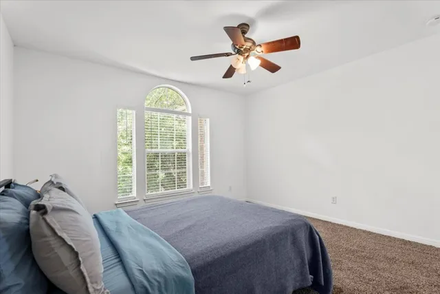 a bedroom with a bed and window