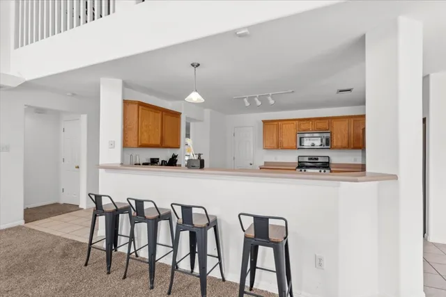 a large kitchen with a table and chairs