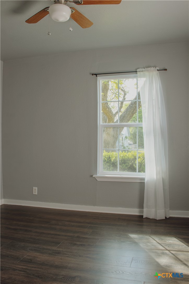 1407 South 7th Street Temple, TX 76504 - Photo 17 of 36 an empty room with wooden floor and windows