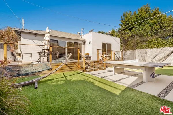 a view of a house with backyard porch and sitting area