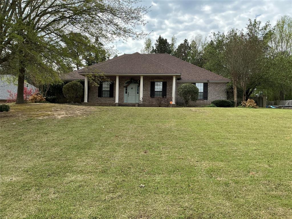 201 Woodhaven Drive Minden, LA 71055 - Photo 1 of 31 View of front of property with a porch, a front yard, brick siding, and roof with shingles