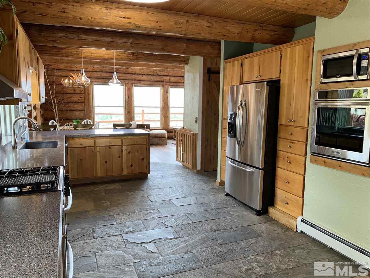 16710 Cheryl Lane Reno, NV 89521 - Photo 11 of 38 a kitchen with stainless steel appliances granite countertop a refrigerator a stove a sink and a microwave