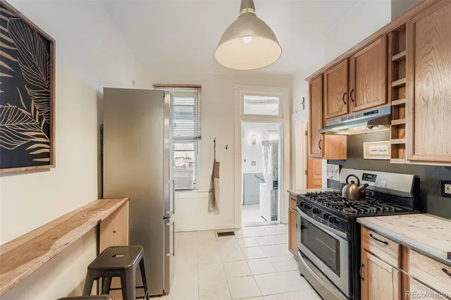 a kitchen with stainless steel appliances granite countertop a stove and a refrigerator