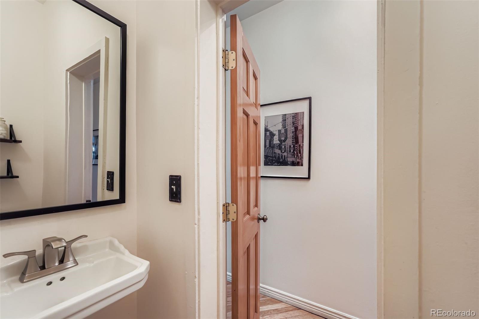 2955 Columbine Street Denver, CO 80205 - Photo 14 of 29 a bathroom with a sink and mirror