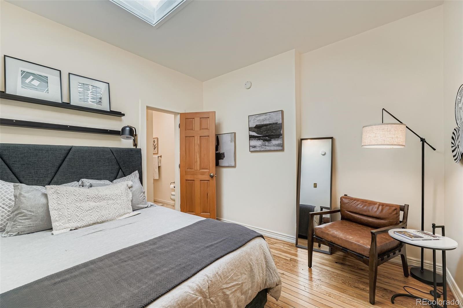 2955 Columbine Street Denver, CO 80205 - Photo 15 of 29 a bedroom with a bed and wooden floor