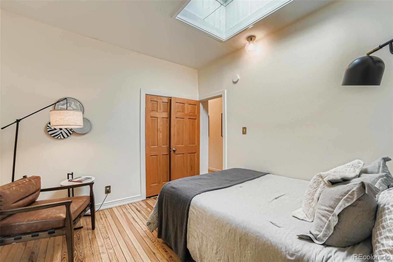 2955 Columbine Street Denver, CO 80205 - Photo 17 of 29 a bedroom with a bed and a chair