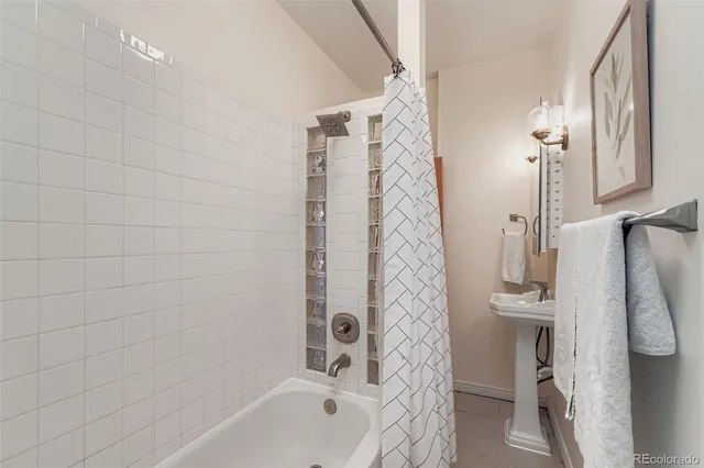 a bathroom with a shower curtain and a sink