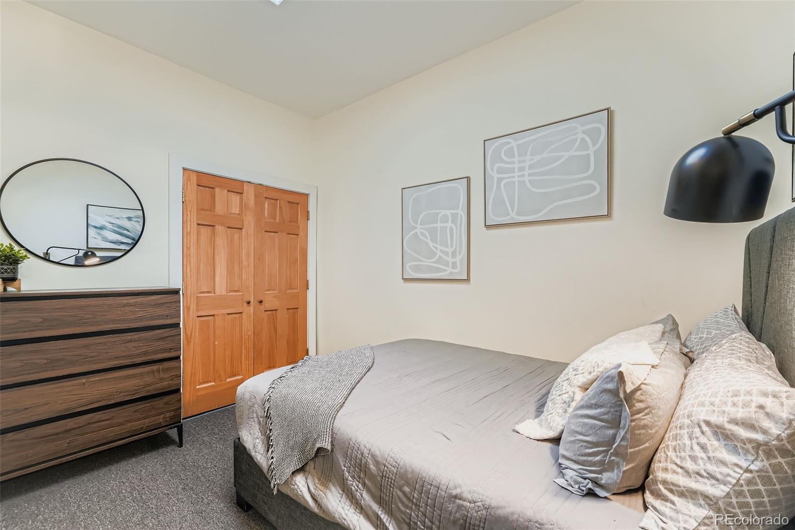 2955 Columbine Street Denver, CO 80205 - Photo 20 of 29 a bedroom with a bed and a painting on the wall