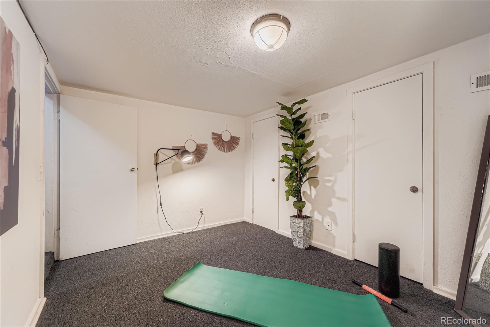2955 Columbine Street Denver, CO 80205 - Photo 22 of 29 a view of empty room with wooden floor and fan