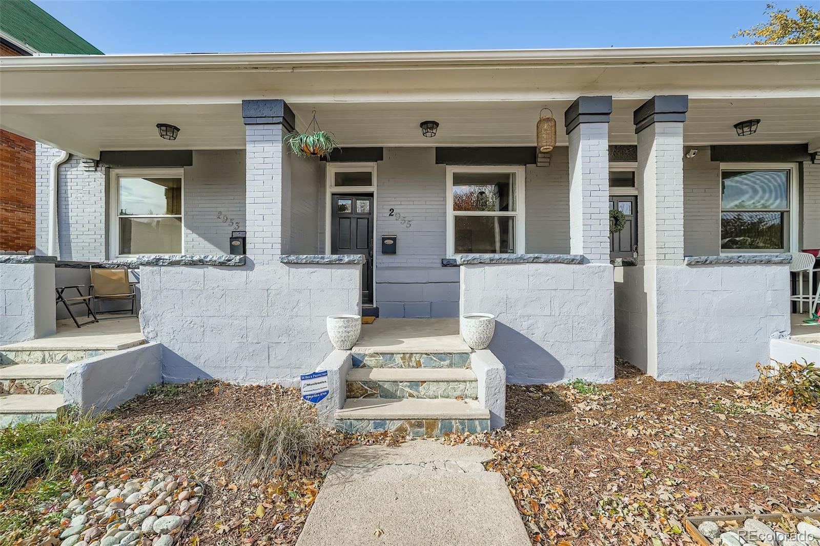 2955 Columbine Street Denver, CO 80205 - Photo 4 of 29 a front view of a house with large windows