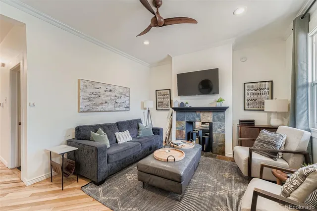 a living room with furniture and a fireplace