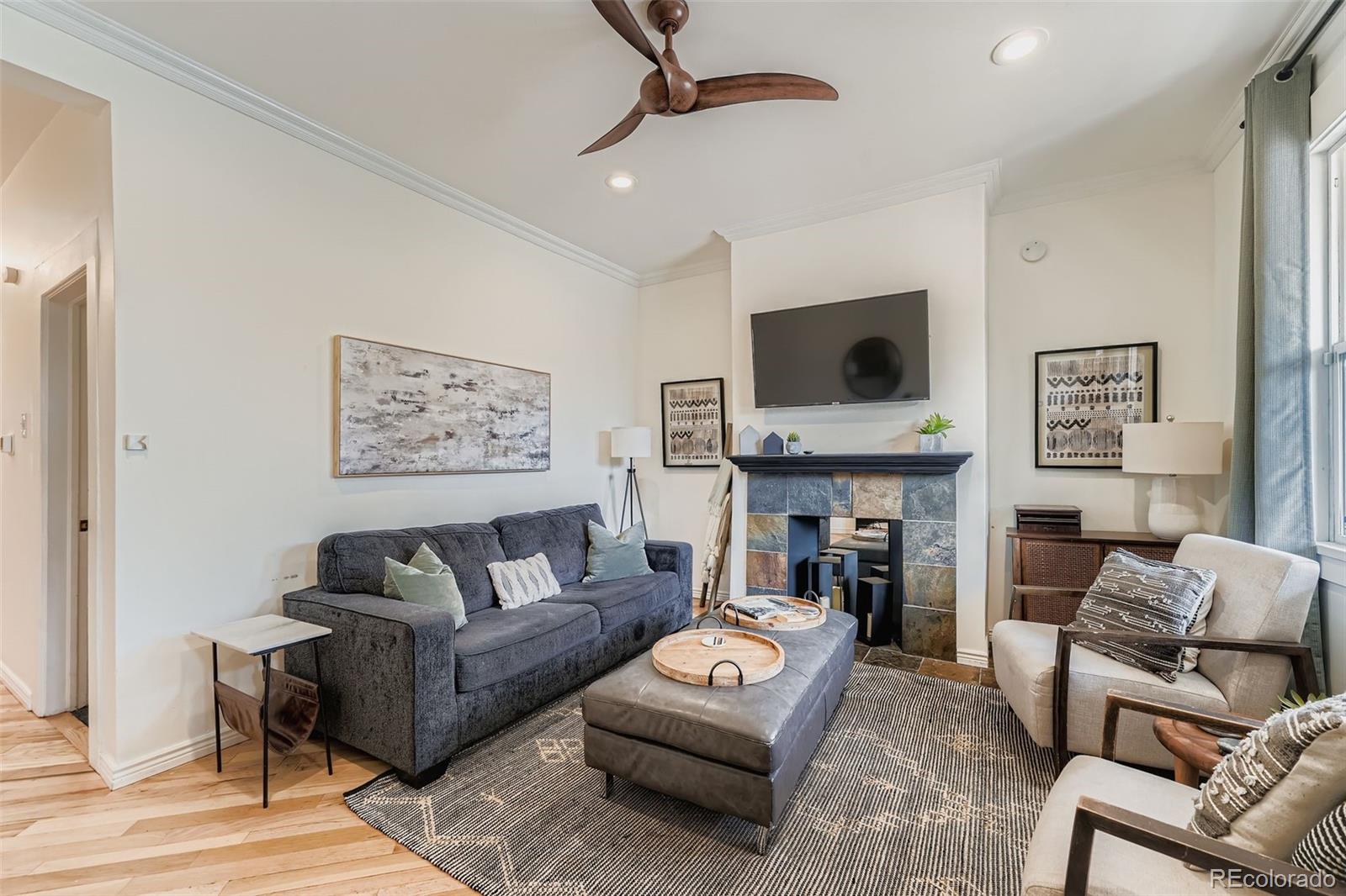 2955 Columbine Street Denver, CO 80205 - Photo 6 of 29 a living room with furniture and a fireplace