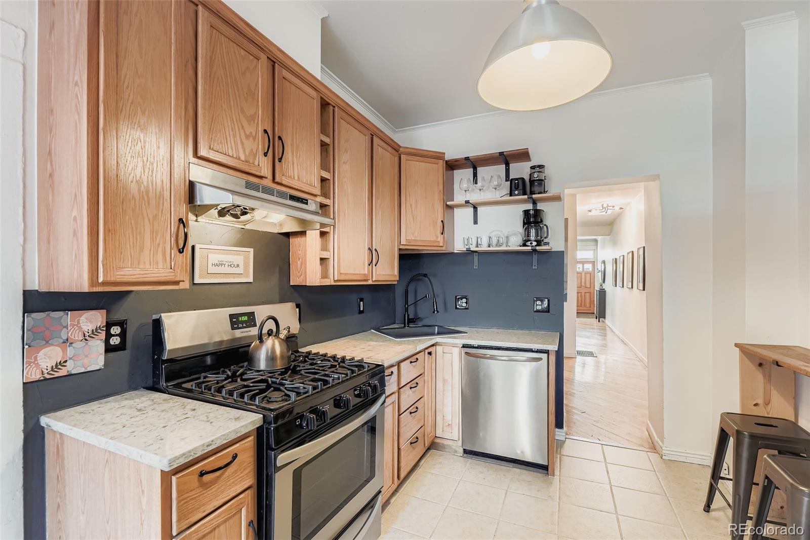 2955 Columbine Street Denver, CO 80205 - Photo 9 of 29 a kitchen with stainless steel appliances granite countertop a stove and a refrigerator