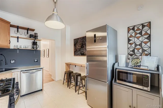 a kitchen with stainless steel appliances and refrigerator